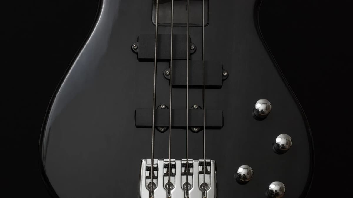 Ein schwarzer E-Bass mit vier Saiten, Tonabnehmern und Reglern. Foto: jonathansautter / Pixabay.